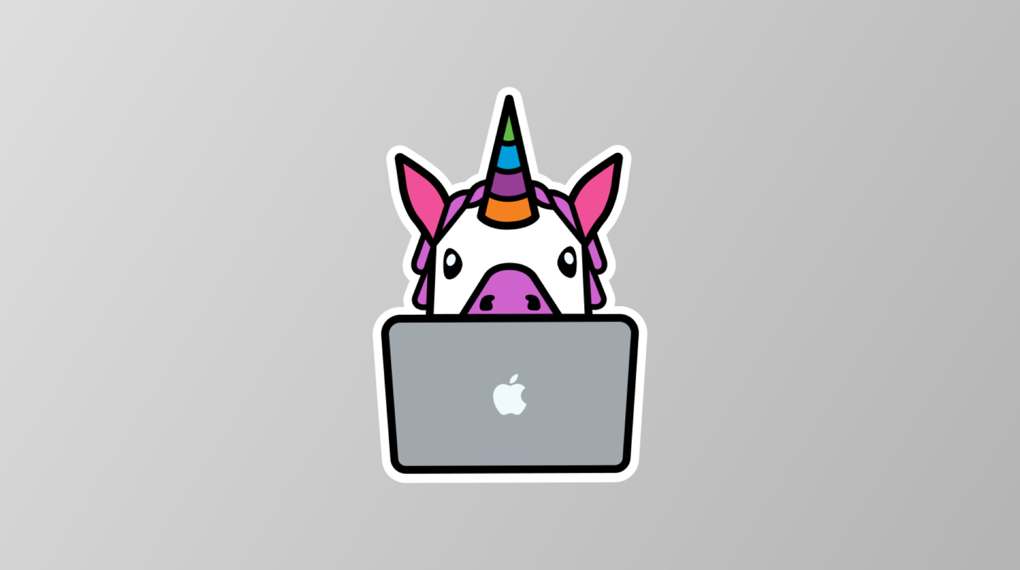 Unicorn Animoji behind the mac on a grey background