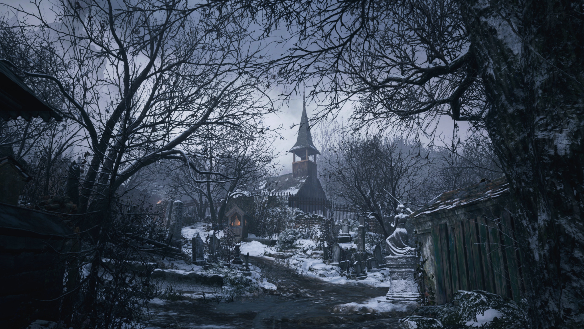 A screenshot of Resident Evil Village that shows a snowy, desolate village with a tall, crumbling church tower visible in the background.