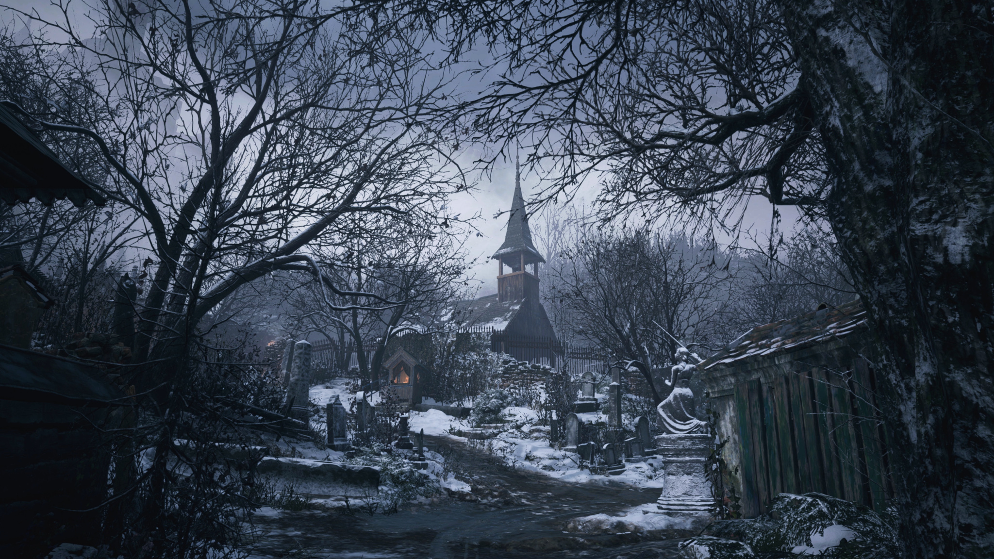 A screenshot of Resident Evil Village that shows a snowy, desolate village with a tall, crumbling church tower visible in the background. 