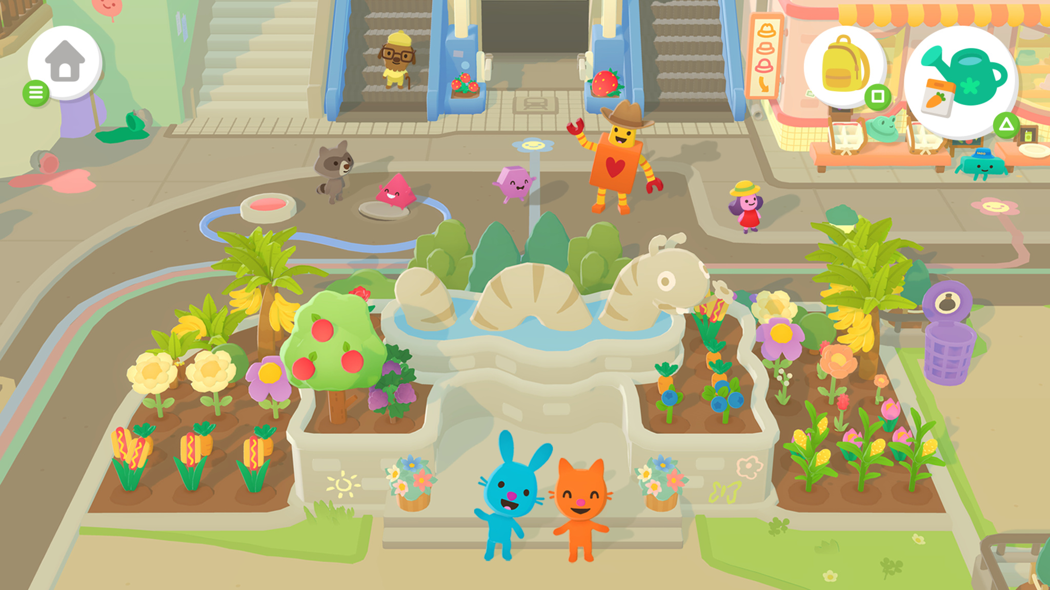 Gameplay screenshot of Sago Mini Jinja’s Garden, a cheerful top-down town simulation game. A blue bunny and orange cat character stand in front of a large caterpillar fountain surrounded by colorful garden beds filled with flowers, fruit trees, and vegetables. Various whimsical characters roam a plaza nearby, including a raccoon, a box character in a cowboy hat, and a small girl in a red dress. Escalators and a shop are visible in the background.