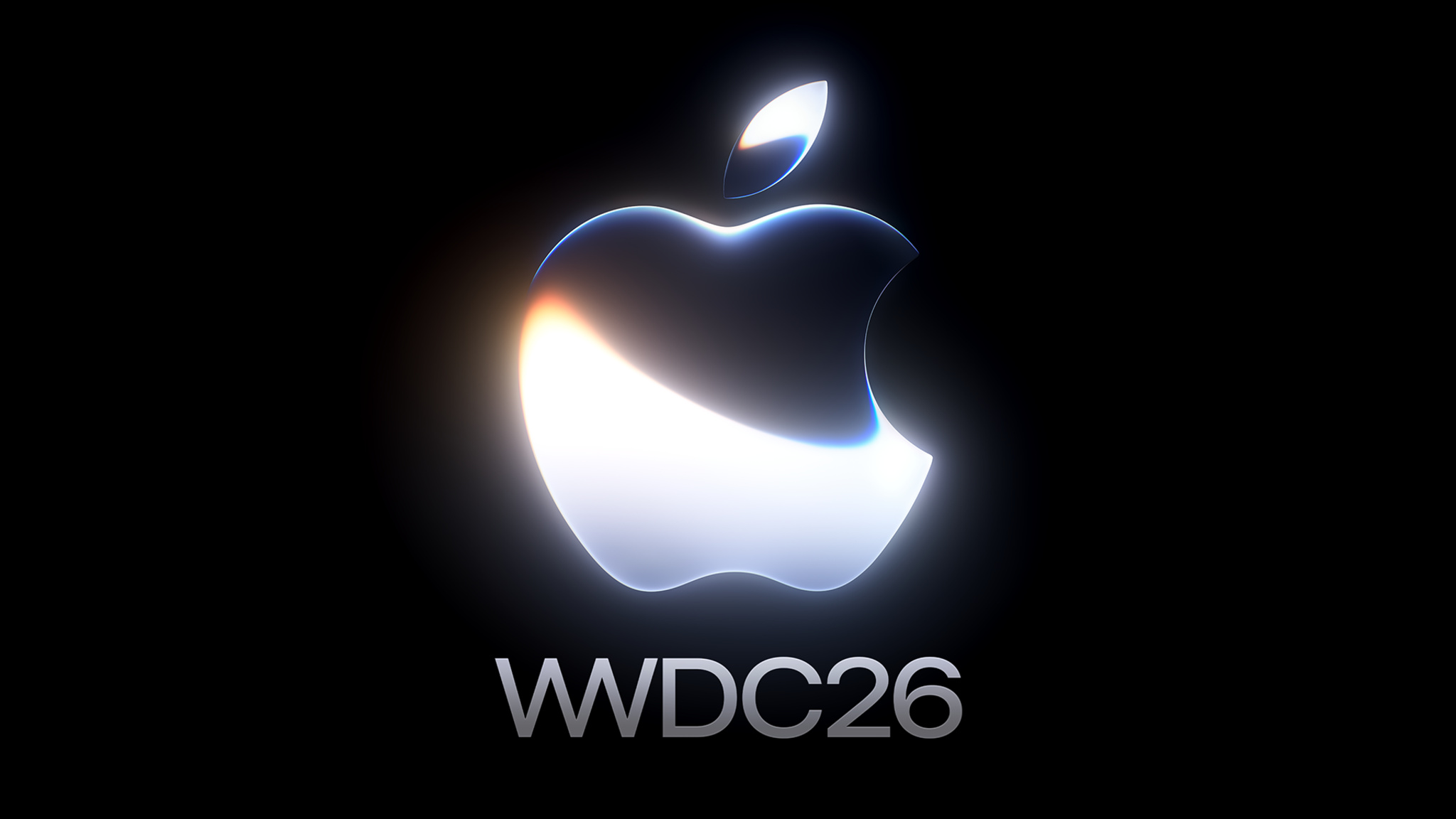 Apple logo rendered in a glowing, three-dimensional metallic style with white, blue, and amber light refractions — centered against a black background, with the text "WWDC26" in silver below.