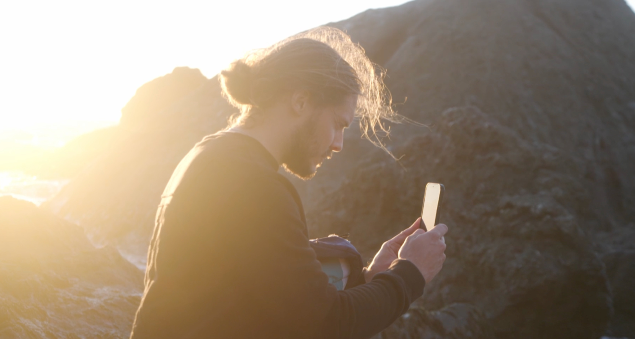 Halide’s Sebastiaan de With is seen taking pictures at sunset in a rocky environment.