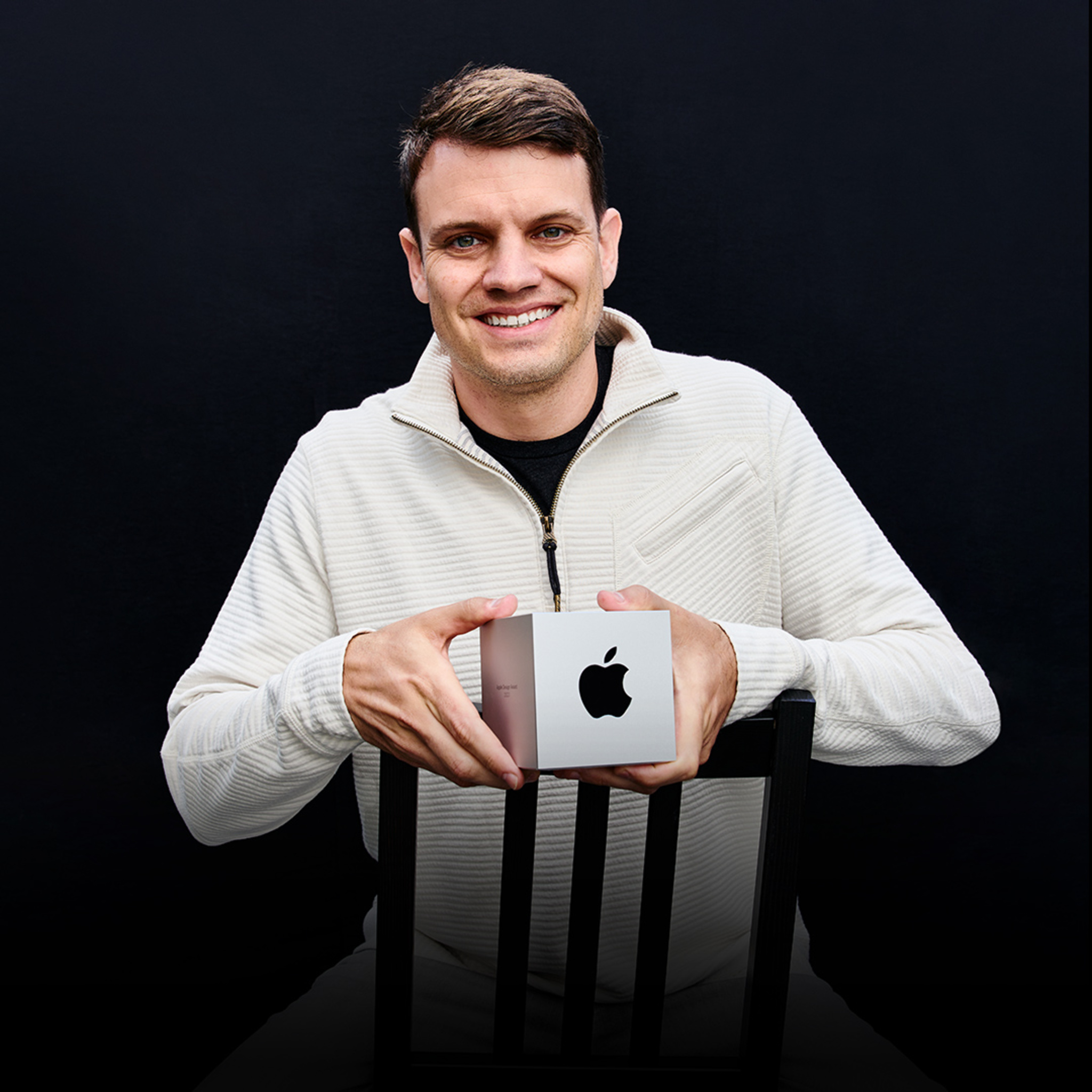 A portrait of Ryan Jones, Flighty founder, holding his Apple Design Award.