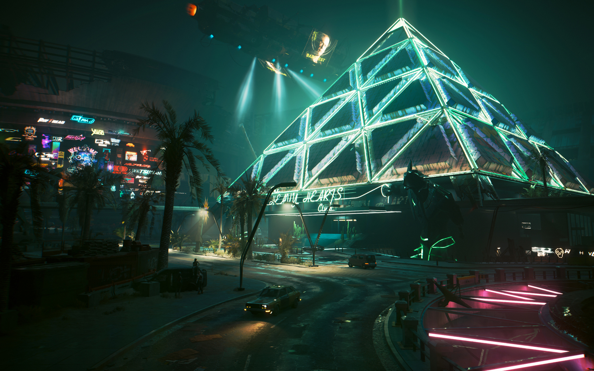 A nighttime street scene from Cyberpunk 2077 dominated by a massive pyramid-shaped building whose geometric steel frame glows with teal neon light. The sign at its base reads "Beautiful Hearts Club," while searchlights sweep the dark sky above and holographic billboards drift overhead. Palm trees and a dense wall of neon signage line the street to the left, as a lone car cruises toward the pyramid.