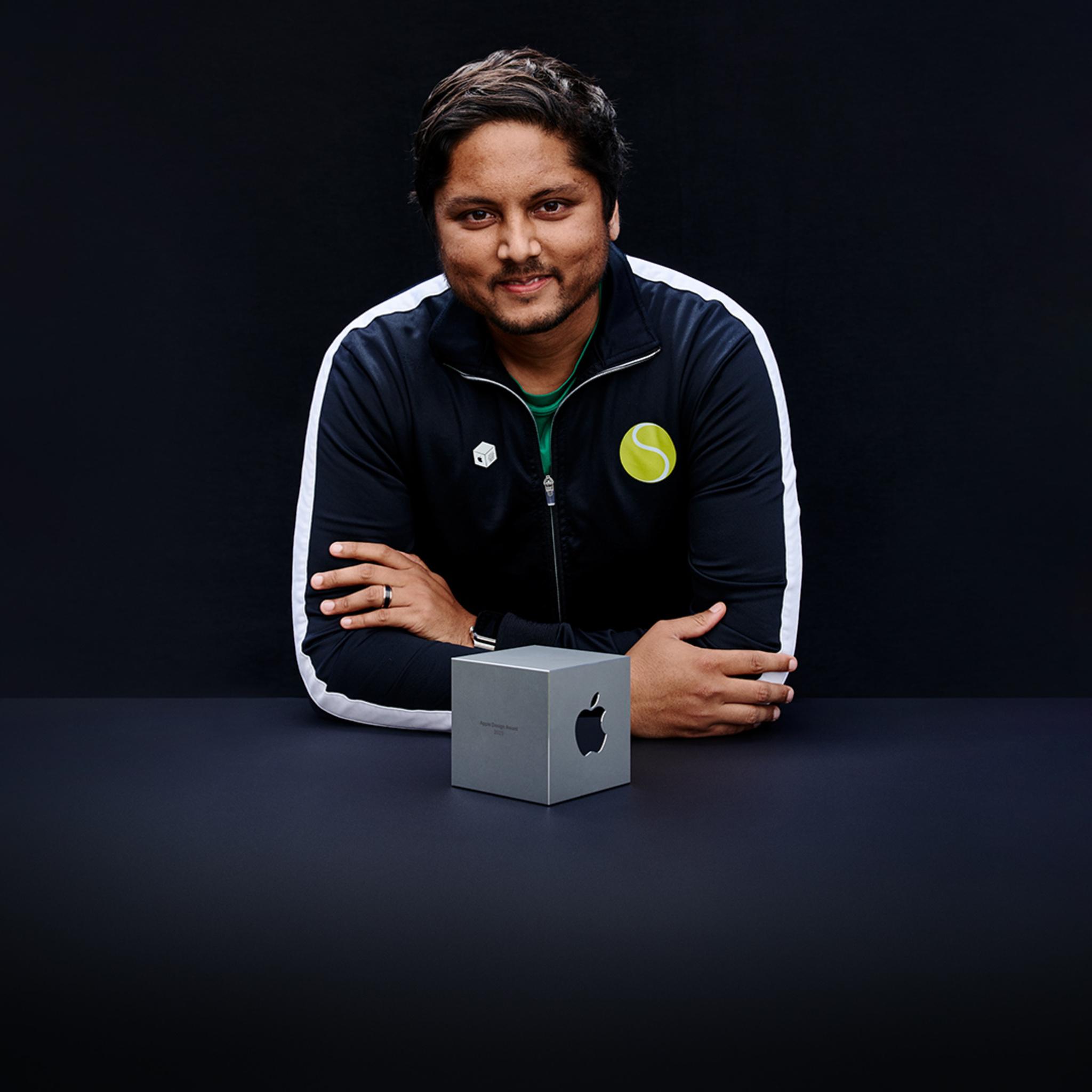 A portrait of Swupnil Sahai, SwingVision founder, holding his team’s Apple Design Award.